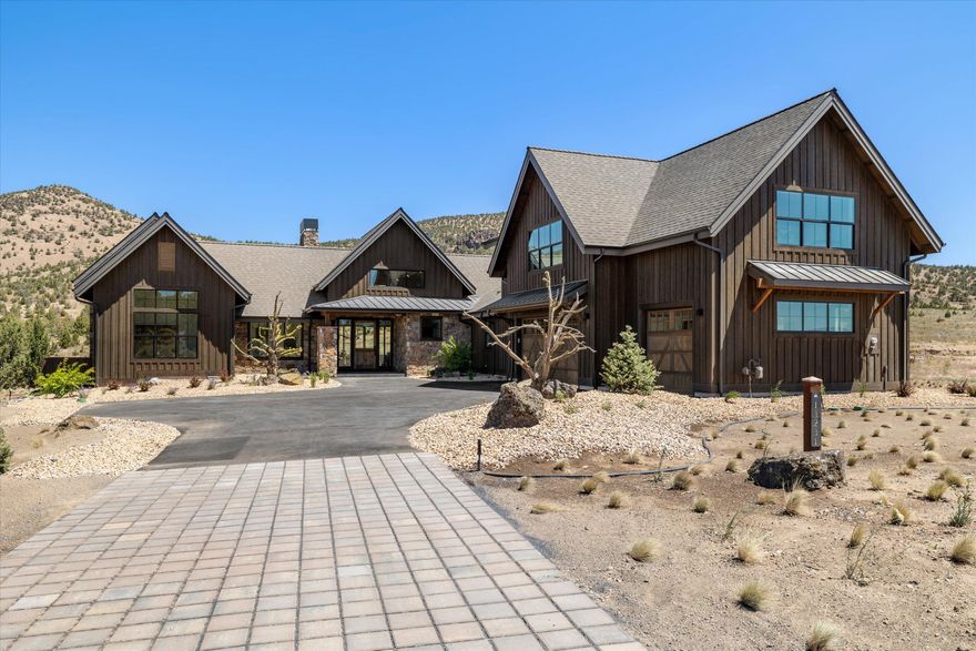 Stunning New Construction home that abuts the beautiful Powell Buttes and boasts of views of the Cascade Mountains to the front. As you enter the home you are greeted with gorgeous sunlight through the windows in the great room. This 3 bedroom, 3 ½ bathroom, home offers an expansive open floor plan with chic contemporary finishes throughout. The kitchen has a large island that is perfect for entertaining, a spacious pantry, and dining area. Beautiful hardwood floors carry through all of the main living areas of this home. The primary bedroom offers amazing views through the wide windows, outdoor access, a large walk in closet and spacious bathroom with a soaking tub. Additionally on the main level, you will find a spacious laundry room with custom storage shelves, a bedroom with an ensuite bathroom, and an office that could be utilized as another bedroom. Continue upstairs to find a large open rec room, extra bedroom, and full bath.  An oversized triple car garage completes this home.