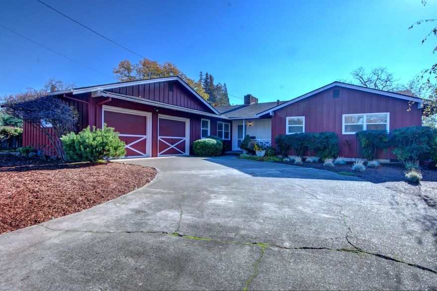 You can't say enough about the location of this home!  Affordable, yet surrounded by estate properties, this Mid-Century Modern home on a spacious lot features an inviting front porch, slate entry, large living  room AND a cozy family room (both with fireplaces), bonus room off the garage, and a great covered patio and inground pool.  Tiled bathrooms, lots of linen storage, double closets in the master, spacious guest bedrooms, and a potential of hardwood flooring under the existing carpeting.  Informal eating area off the kitchen, and formal dining room with hardwood flooring.  Kitchen also has a breakfast bar.  Newer vinyl windows, A/C, dishwasher, fencing, and new garbage disposal and pool pump.  Family room fireplace plumbed for gas.  Large picture windows overlook the pool and back yard.  Currently there's a vacant lot behind the home for a sense of privacy.