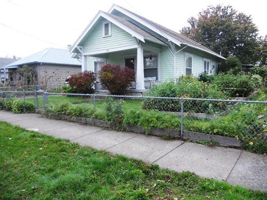 Clean, charming, and adorable cottage with 2 bedrooms and 2 full bathrooms. Lives larger than its 1,256 sq ft. All of the rooms are good-sized with high ceilings. Very Spacious living room with a beautiful free-standing gas log fireplace which heats the entire home and makes it cozy on chilly winter evenings. Newer carpet and interior paint. One bedroom is currently being used as an office. The master bedroom suite is in the back of the home for privacy. The roomy attic space with pull-down ladder is waiting to be finished. This home also features a huge sunny kitchen and dining area large enough for a full-sized table and chairs set, a walk-in pantry/utility room, a big laundry room, a covered patio, many raised garden beds, and an over-sized one car garage with a workshop area including a workbench and shelving for great storage. There is additional off-street parking, a covered carport, and a fenced front yard for growing lots of vegetables and flowers.