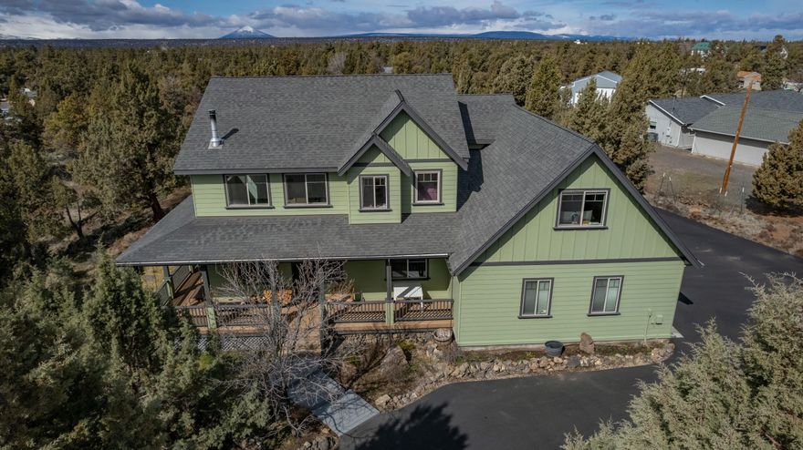 Beautiful Craftsman-style home with almost 3 acres, on a cul de sac, with mountain views from the second level. The home features a recently asphalted 8,500 sq ft wrap around driveway, newer HVAC / blower system, newer interior / exterior paint and updated lighting along with a newer Bosch dishwasher. Upon arrival, be greeted by the covered deck that wraps around the side of the house with views that overlook the lower part of the property and kids play structure. This 2350 sq ft home includes an office / guest room on the main level, 20 ft vaulted ceiling with abundant natural light, and bonus room upstairs. The kitchen, utility room, & bathrooms have granite counter tops. This property also features an attached two-car garage, a detached 24' x 24' shop with 220/240v, and RV or boat parking area. The great landscaped backyard has automated sprinklers and is surrounded by trees/plants with their own drip system. The Deschutes River, BLM land, and trails are close by. Don't miss out on this Central Oregon gem!