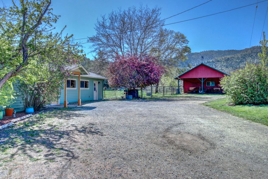 BIRDSONG FARM! Rural living at its best. Come experience tranquil living in a recently updated Craftsman style home on 5.02 flat, irrigated EFU Zoned land in the desirable Griffin Creek area. Detached 1120 sf Shop/Barn with hay storage and stalls w/ paddocks. Open riding arena, inground pool with solar heating. Solar electric panels keep electric bill down. Updates include; new roof, Hickory wood floors, double pane windows, Hardie plank type siding, solar tube, Jotul woodstove, 18 Sear heat pump, and solid wood doors. The kitchen remodel includes new quartz counter tops, black stainless steel appliances, alder cabinets with soft close feature, pantry pullouts. The laundry has new quartz counters and stainless steel washer and dryer. Attached office with separate entrance for additional utility. Small orchard area and hay field with Class 1&2 soils which have been farmed organically for over 20 years.