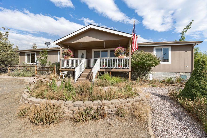 Perfect location for convenience and privacy! 2.41 acres in Whispering Pines holds this spacious, double wide, manufactured home, anchored in a foundation, and is your quiet oasis between Bend and Redmond. With a detached 20x24 garage, circular driveway, and natural landscape on the property, this home is ready for you with all that you need - a 3 bed and 2 bath Skyline home complete with vaulted ceilings and space to spread out.