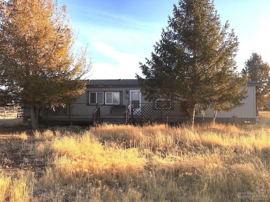 Here is the perfect investment property at a perfect price! With a little love, this 1620 square foot home on nearly two acres can be your masterpiece! Fully fenced and gated to keep your critters in and a turn-a-round driveway with an RV pad for your when friends and relatives visit! Peek-a-boo views from your back yard which has been picked of rocks for easy maintenance! This home has a bedroom off the entryway with French glass-paneled doors that would make the room a cozy den or study. Choose between relaxing in one of two living rooms, one of which has piping installed for a new wood stove! Master bedroom is separated from the other rooms with a large walk-in closet. Bring some elbow grease or your contractor out and give this home new life before it's gone!!