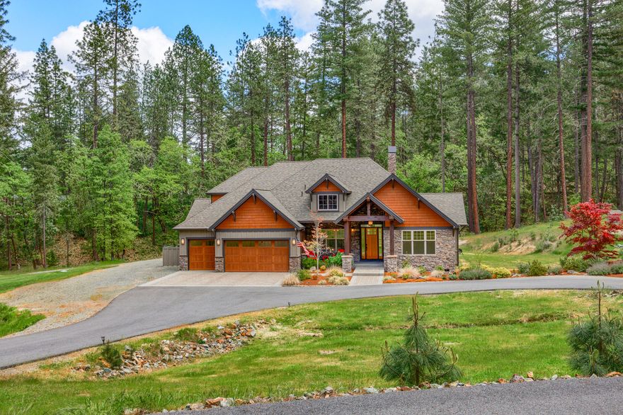 Welcome home to your exclusive getaway through the gates of Ponderosa Ridge Estates. Set inside a cove of mature evergreens, a circular driveway enters to this 2014 Mascord-designed home on 3.46 acres. 3,266 sq. ft. customized from top to bottom & maintained in prime condition. Outdoor serenity enters through every window- the perfect backdrop for the stately, open-concept interior. Great room framed by towering clear-cedar vaulted ceilings over hickory hardwood floors & floor-to-ceiling windows. Heat & Glo wood-burning fireplace. Gourmet kitchen w/Thermador 6-burner gas range, commercial-grade hood & double oven, granite counters, expansive island/bar, soft-close cabinetry,  pantry & more. Split floorplan w/lovely master ensuite & bright office at south end opposite guest bedrooms & full bathroom on north end. Spacious upstairs bonus room for separate entertaining or guest quarters w/murphy bed & full bathroom. Must tour- the grandeur of this property is only discovered in person.