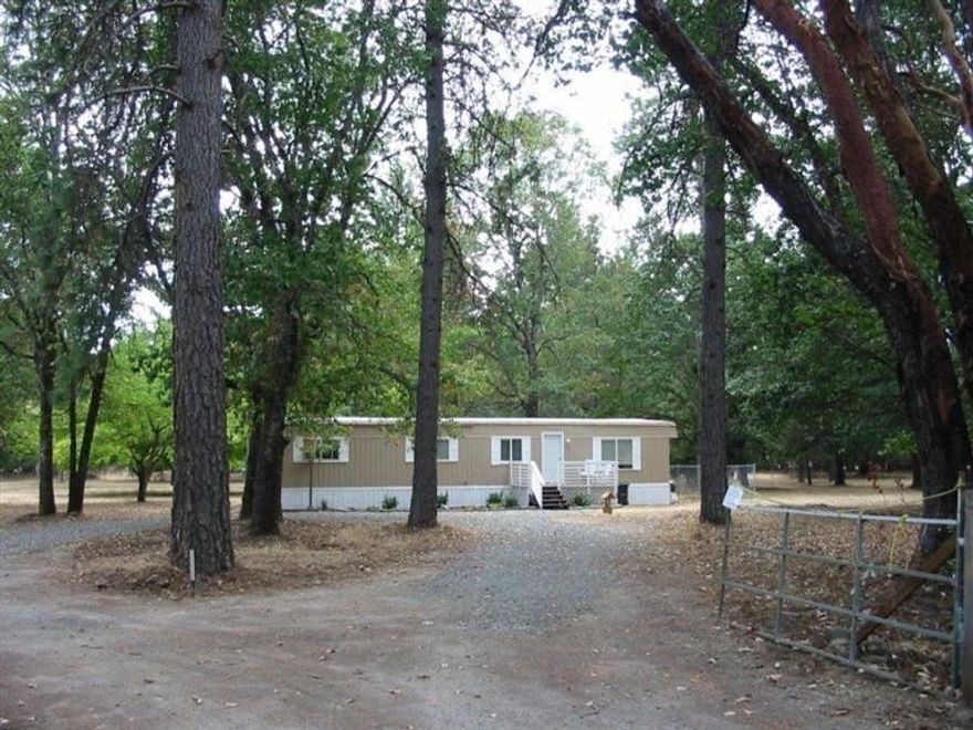 Very nice level wooded setting located in the North Valley area on 2.5 acres. Plenty of room for gardens and animals. There is a 1969 doublewide that has been updated and is a very comfortable home or live in it while you build your dream home. Manufactured home is detitled - Sold As Is.'' Must make an appointment.