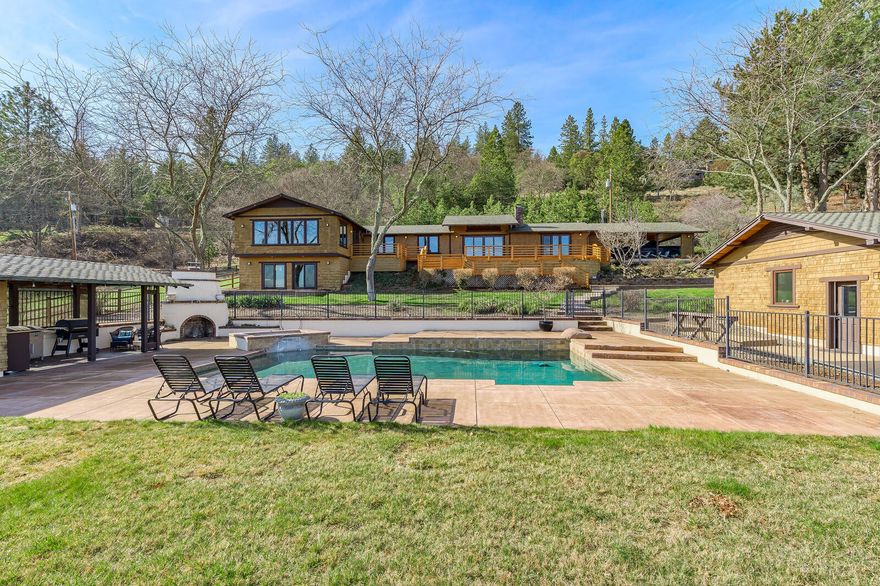 An exceptional Arts & Craftsman style home in alluring Central Point countryside on 5.95 acres... Light and bright this capacious 3346 sq ft home hosts a split floor plan w/ 2 masters w/ ensuites for total of 4 beds & 4 baths, and showcases breath-taking valley views from its abundant windows. A spacious kitchen with custom cabinetry and Viking stainless steel appliances combined with a two bonus rooms & a large wood-burning fireplace. Great for entertaining, yet provides an intimate warm atmosphere. Relax or sunbathe on the inviting patio where you can enjoy the sunset on the distant hills on a warm evening, cool off in the saltwater pool waterfall feature, warm-up on a chilly night in the Pebble Tec Hot Tub, or entertain under the cabana with the outdoor kitchen and propane fireplace. Large dual-bay heated and cooled garage, 34' x 22' metal shop with concrete pad, hook-ups for RV parking. This exceptional home has so much to offer and it's all waiting for you to call it home