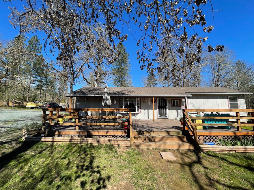 Perfect investment property! This lot includes two legal dwellings: 3 bed 2 bath manufactured home w new tubs and cosmetic touch ups; 1 bed 1 bath well maintained stick built home. Plenty of sheds throughout the property for optimal storage, small barn/coop, RV space, fenced garden area, gorgeous trees, all on a private 2.6 acre lot that is completely fenced and gated in front with a remote! Opportunity for multifamily or investors! Come check it out today!