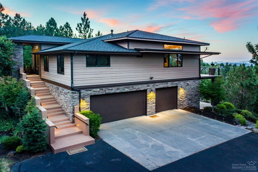 Awbrey Butte entertainer's dream. Breathtaking city views invite you through beveled stain glass French doors. Tranquil atmosphere with upper/lower decks to enjoy the beautiful scenery Central Oregon has to offer. 4 sliding glass doors make up the entire wall of the main living space. Stunning Chef's kitchen complete with a large island & griddle, subzero wine cooler, high end appliances, walk-in pantry, travertine tile throughout, and plans for dumbwaiter to be installed. French doors lead into the master suite with an effervescence Kohler infinity tub that fills from the ceiling into an overflow channel for a deep soak with an infinity pool effect with chromotherapy. His & her closets, walk in shower, & a private spiral staircase leads downstairs to a theater room, bonus room/ bar, & pool table. The home is connected to Crestron remote surround sound & lighting system. Solar power 3.8 Kilowatts, outdoor hot tub, central vac, home warranty, & snow blower all included in sale.