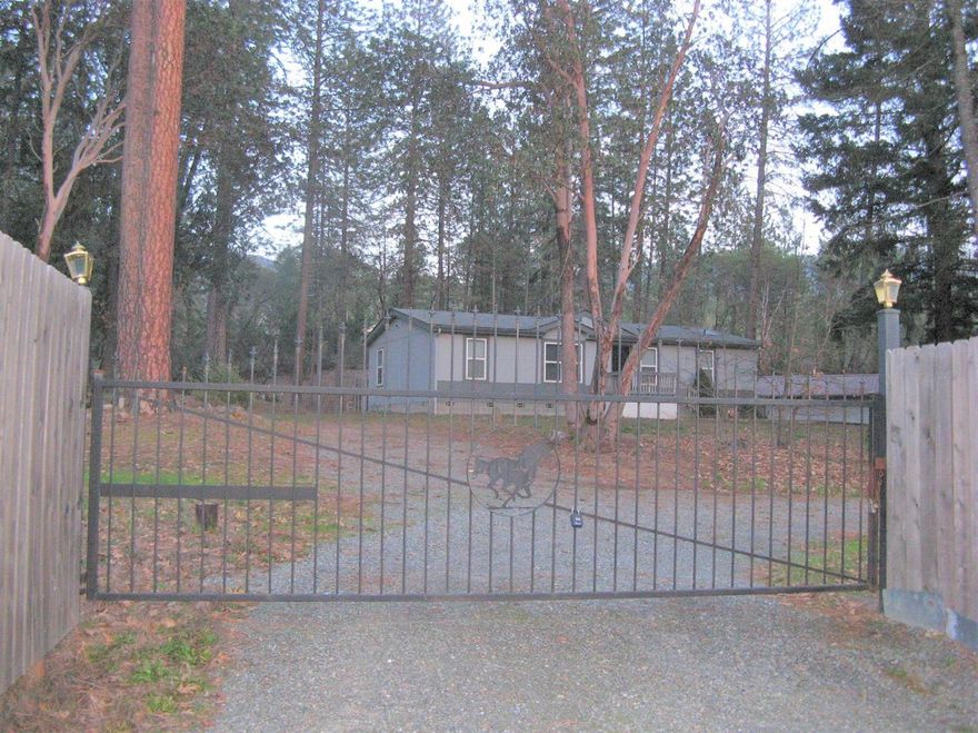 Incredibly maintained neat as a pin on 1.59 ares. Lovely 3 bedroom, 2 bath, 1344 sq ft Manufactured home. Beautiful setting, tree studded property, fenced with privacy gate. Brand new carpet, freshly painted inside and out, Move in ready, just for you. Amazing stamped concrete patio and pathway for all your special BBQ gatherings or entertaining. Nice single car detached garage and carport. Plenty of room for horses and toys. Very light and bright and open feeling.