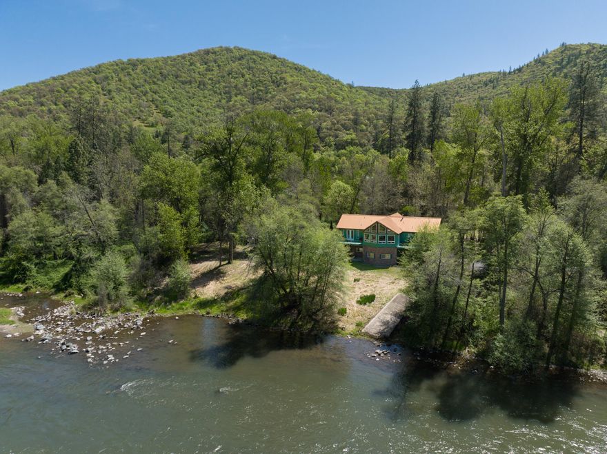 Beautiful 5-acre retreat on the mighty Rogue River. Approximately 675-ft of river frontage with a boat launch. This property is gated with vinyl fencing & a paved drive. Gold Nugget Park is across river, so no home, just nature. This custom home has 2,304-sq. ft. on the first floor & 2,250-sq. ft. on the lower level. The lower level has two 2-car garages with elevator access to the first floor. This level is equipped with game room, second kitchen, bathroom, bedroom & office areas. The first floor offers two master suites with walk-in closets, marble step in shower and 13x15-loft. All interior doors are solid wood & interior insulated walls. Floors are engineered rustic oak hardwood, ceramic tile or marble. Four sets of French doors accent soaring 18-ft vaulted ceiling with unobstructed view of the Rogue. The kitchen has a farm, country feel with stainless steel appliances and a nice breakfast bar that attaches to the dining room. Furniture will stay with property with accepted offer.