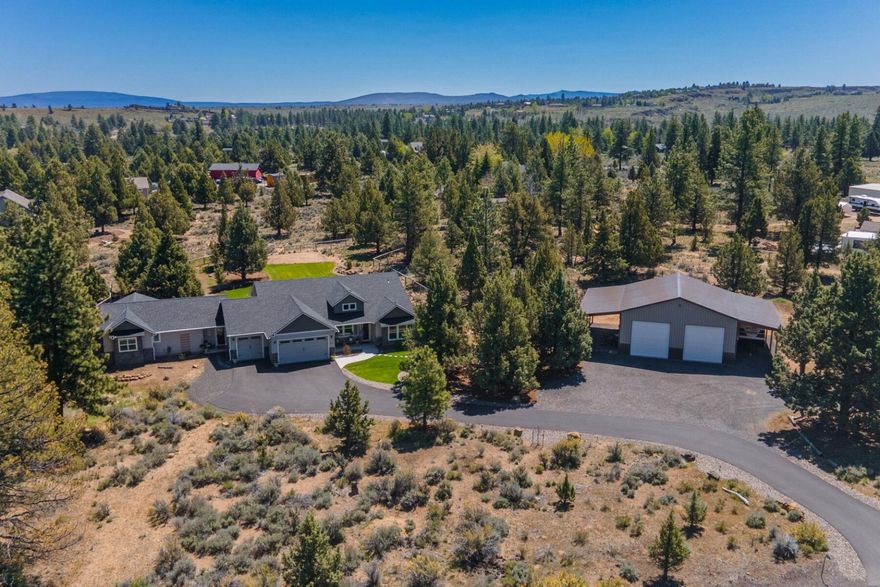 Welcome to Sundance! Just minutes from Bend on 2.96 acres this single level home includes a fully permitted guest/ in-law suite added in 2022, 3-car garage & shop! The main house is 2,046 SF with 4 beds & 2 baths while the attached guest suite is 1,217 SF with 1 bed, 1.5 bath. The two spaces can be one large home or locked off for separate living. The kitchen is complete with quartz counters & stainless appliances plus many large windows provide an abundance of natural light. The main primary bathroom has a soaking tub, dual sinks & large walk-in closet. The in-law suite features a half bath, living room, kitchen & second primary. Enjoy the fenced private backyard with 2 separate patio spaces, hot tub & fire pit. All this plus 1,296 SF shop with 12X36 covered parking on each side, 200 amp electrical service, 2-12' doors, full bathroom, 50 gal. water heater, heated 12x12 room, upstairs hobby area & storage. Plus, take advantage of easy access to National forest, & trails near by!