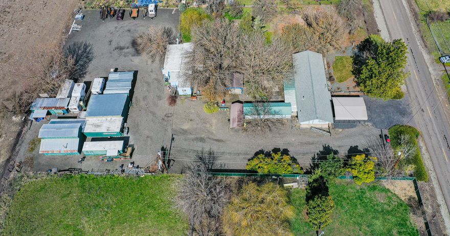 This property has been in the family since 1968! The main house offers 4 bedrooms, 2 full baths, a recently remodeled kitchen & master bath. There's a 1970's ish mobile home that was moved onto the property aprox 30 years ago. It has an attachment added on that makes for a nice living room & oversized room that is presently being used as the main bedroom. Don't be fooled by the exterior looks, as the inside is really nice! The kitchen has been completely remodeled w/ knotty pine wood that came from Lost Creek Lake area. Appliance barn, built in micro, oven range, trash compactor, roll outs & more! All new vinyl windows thru-out. There are many outbuildings, and a barn that was used for wood working, raising sheep, cows & chickens over the years. There's also a 50's mobile home that is now sitting empty. It has newer interior paint & newer carpet inside. No oven/range or fridge, but w/ full bath. Buyer to do own due diligence as far as financing. Check w/ RCU.