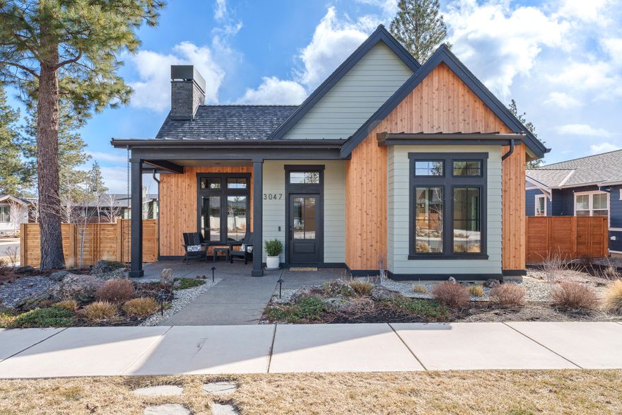 Welcome to 3047 NW Tharp Ave, a stunning custom-built home by Wilcox Construction Inc. in Discovery West. This 3-bed, 2-bath, 1,858 sq. ft. home sits on a prime corner lot and was completed in 2022. Designed for modern living, it features vaulted ceilings, a sleek fireplace, and an open-concept layout filled with natural light. The chef's kitchen boasts custom cabinetry, high-end appliances, and a spacious island. Retreat to the primary suite with a spa-like ensuite and walk-in closet. Two additional bedrooms offer space for guests, a home office, or hobbies. Enjoy seamless indoor-outdoor living with a private courtyard and custom fire pit, perfect for entertaining. The oversized garage offers extra storage for all your Central Oregon gear. Located in one of Bend's most sought-after communities, you're just steps from parks, trails, and outdoor recreation. A must-see!