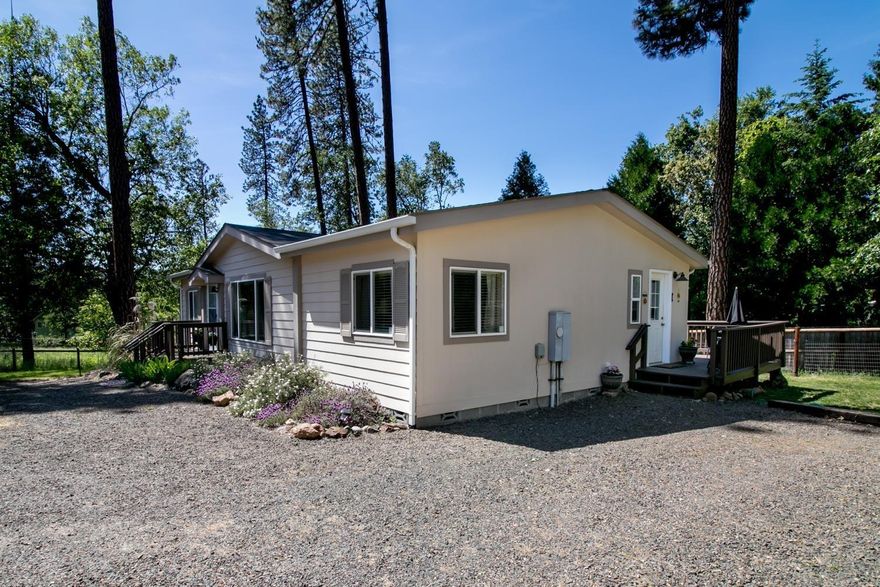 You will love this peaceful, updated, Shady Cove retreat, just a few minutes' walk to the shores of the Rogue River. The Cove Association allows private riverfront access to its residents. Three bedrooms and two bathrooms with open floor plan and vaulted ceilings, new flooring and interior paint throughout. Kitchen island is the perfect preparation space while visiting with guests in the living and dining areas. All appliances are included along with all window treatments! Multiple yards- some fully fenced- ready for gardening, pets, or a place for the kids to play. Relax with a meal on the newly refinished deck and roast marshmallows over the backyard fire under the stars. Abundance of parking space for you and your guests. Store your RV outside or pull it under cover through the large sliding shop door. For your hobbies and storage, utilize the 36'x30' shop with 15'x12' insulated storage room. Is this your next place to call home? One listing agent is related to seller.