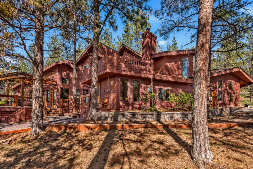 Experience the warmth of natural light, reclaimed regional wood, and panoramic Cascade Mountain views in this one-of-a-kind architectural home on over 3 fully fenced, gated acres in NW Bend. Tucked among the pines with a massive pull-through driveway, this private estate features split-level living, spacious rooms, updated bathrooms, and a newer roof. Enjoy vast outdoor living spaces with multiple decks, private courtyards, and a detached studio ideal for creative or flexible use. The oversized garage offers room for all your gear, with space to park your RV, boat, or other toys. No HOA or CC&Rs. Minutes to Shevlin Park, Downtown Bend, and westside schools, with trails, nature, and mountain views at your doorstep. Over $400k in home improvements by current owner.