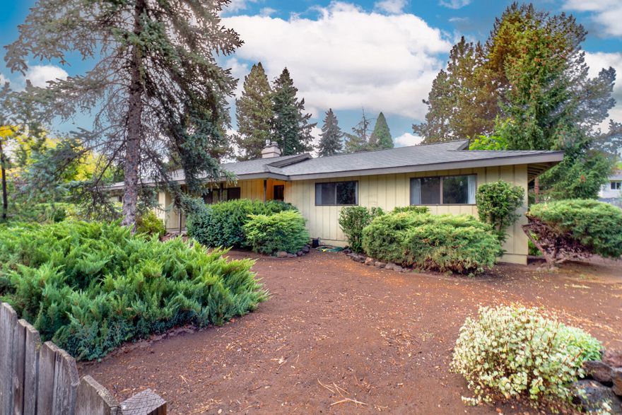 One owner, custom built home has so much vintage charm!  Spacious 3 bedroom, 2 baths, family and living rooms with large, functional kitchen, complete with island and work center.  There is a gas fireplace with blower for added comfort on a thermostat and remote, along with a real wood burning fireplace in the living room. The oversized, finished, double garage has a separate work room for tinkering, two garage doors,  plus ample attic storage. Nice covered back porch for grilling or just back porch sitting. This incredible .38 acre lot provides an abundance of room for gardening, RV parking, ADU placement, or whatever you can get approved through the City of Bend.  No CC&R's or HOA.  Located in convenient midtown with all the perks of public services. Make this special home yours!