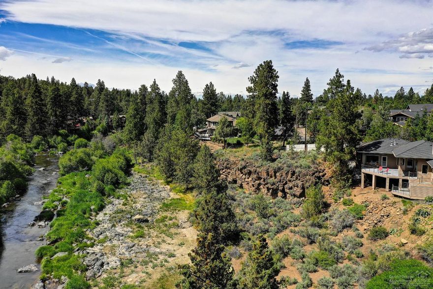 Casually elegant one level home on 1/2 acre w/Deschutes river views & a coveted short-term vacation rental permit. Easy access to the river, trails, Sawyer Park. Gated entry. 3 bedrooms, 2.5 baths & small office. High end finishes, gorgeous hardwood & stone floors & custom built-ins. Great room w/wood burning fireplace, dining area & gourmet kitchen open to living & dining with stainless steel appliances. The Master suite has stunning river views, deck access, a huge walk-in closet & bath w/marble floors & large soaking tub. Enjoy the best of indoor/outdoor living on the large deck for entertaining or relax in the hot tub with the views & sound of the river. Large utility room with tons of cabinetry & heated finished bonus room off lower deck. Generous parking & turn around area, covered breezeway & over-sized garage. This is a special opportunity to own a home that offers not just the views but easy access to the river as well, perfect for your private getaway or for use as a VRBO.