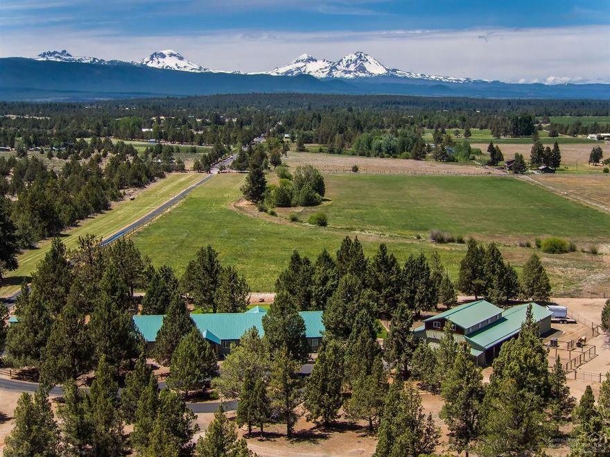 Exquisite Cascade Mountain Views from this Tumalo Ranch. Exclusive privacy & peace. Lush green easy care 16.3 acre TID irrigation. Fully fenced, paved, gated drive. Single level home uniquely designed to incorporate an expansive great room, open gourmet kitchen & dining. NW style beams, wood & stone lead to master & guest bed & bath. Beautiful barn w/tack, 3 stalls, dry lot, round pen & pastures. 4 bay shop plus another ideal workman's super shop'' 3bays with bath and extensive cabinetry for the car buff.