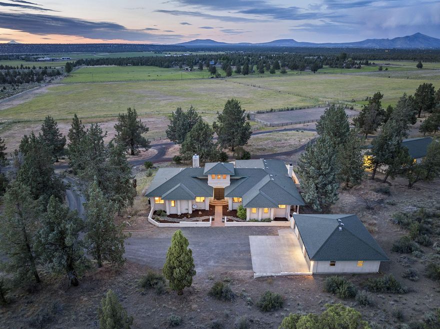 Situated high on a ridge with expansive views of the Cascade Mountains and rolling fields, this one of a kind, single-level, Santa Fe inspired home is loaded with warmth, character and  authentic architectural details that include arches, rustic wood beams, tile floors and Santa Fe style doors. Open Great Room includes a cozy sitting area w/fireplace and elegant dining space.  Entertainer's kitchen has a breakfast nook and door that opens to a large outdoor space for enjoying incredible sunsets and stunning landscape. Primary suite has a private entrance, luxury bath, walk in closet and soaking tub. Two guest rooms share a bath. Wonderfully designed equine spaces include two expansive loafing sheds, six-stall barn with tack room, hay storage, a large outdoor arena and multiple cross-fenced paddocks.  Huge detached shop w/ two large bays and workshop.  Add'l two car garage.  Bordering private lands for miles of riding.  Sellers will give a credit for some of the deferred maintenance.