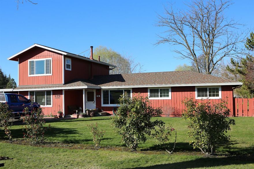 Gardener's Paradise! Country living minutes from town. Lovingly cared for 4 bedroom, 2.5 bath home has been in the same hands for almost 40 years! Master suite and family room addition built in 2000 takes advantage of the pastoral views of vineyards and rolling hills. This 1.02 acre park-like setting of expansive lawns, gardens, fruit trees and berry bushes are economically watered by M.I.D. irrigation. ($172/yr.) and Medford water. Original oak flooring in part of the home preserves the timeless beauty of days gone by. Brick hearth and certified wood stove insert adds to the charm. Newly resurfaced kitchen cabinets, whole house fan air circulator, large utility area and attached workshop. Relax on the huge covered deck while you enjoy the views of the beautiful fenced back yard. Detached out buildings for tool storage. Plenty of room for RV or boat parking. Located on a quiet country road that gets sun all day long. Snap this one up before someone else does!!