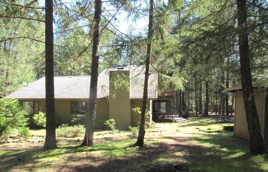 This is the Oregon Dream! Custom built in 1979 this 3216 sq.ft. home features 2 master suites, one on the main floor & a huge one upstairs with sitting area, laundry chute and deck. Home is surrounded by 10 level, forested acres, zoned EF with large fenced southern exposure garden area and sweeping mountain views. Oversized living room with rock fireplace, dining room with built in hutch, kitchen with tile counters and an abundance of cabinetry and built-ins throughout. Adjoining the kitchen is a quaint breakfast nook with built-in hutch that easily could be a craft room area or office, you decide. The covered back patio looks out onto the beautiful grounds and tall timbers. Stroll with coffee in hand each morning along the walking trails and enjoy this peaceful sanctuary. Great well per seller, guest cottage, outbuildings & RV parking with water and power are just a few of this home many fine amenities.