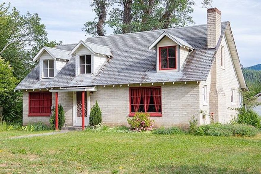 1940s farmhouse with English Cottage appeal just miles from town. Original flooring and vintage character throughout with all new wiring and plumbing. Applegate (rapids) riverfront. Wildlife. Irrigation Rights. South facing view. Dream come true type property. CASH - As-Is.