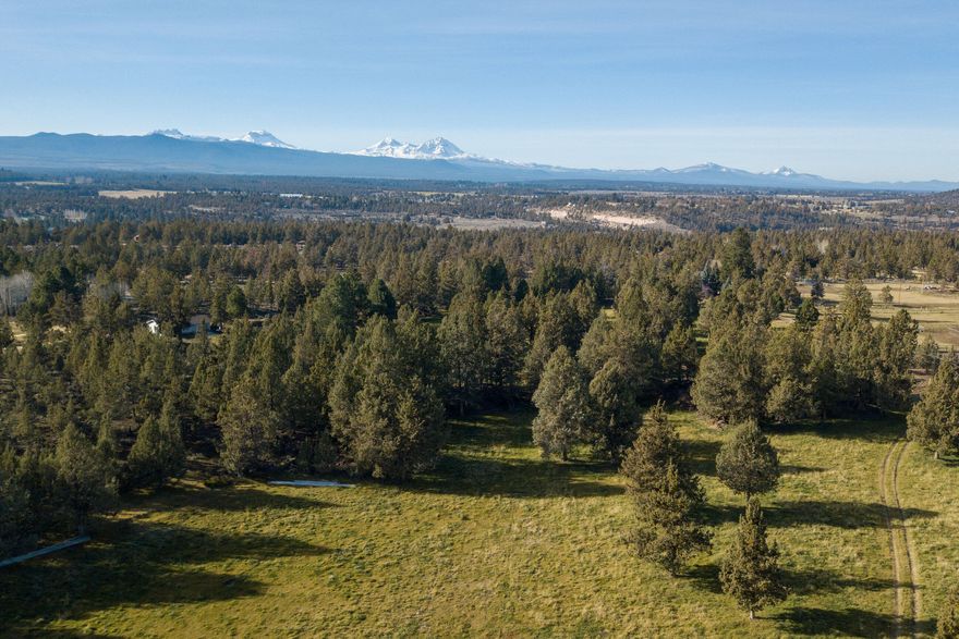 Picturesque-stunning-irrigated-view land,  prime close-in location!  You've been waiting for that special property to build on, or hold, and this one has it all.  Close to town this 36+ acres is fenced, gated, irrigated, has paved road frontage.  Lovely NW Bend acreage is situated near the edge of town, but convenient to Redmond, Tumalo, and Sisters.  Several nice out-buildings already on-site, mature trees, rock outcroppings, amazing views, this offers many possible sites to create your own private hidden dream home.  Scenic ponds on the property for irrigation water; great for grazing, pasture, or your choice.  May be possible to split this property ( talk to county planning ) if more than one home is desired. Currently zoned MUA-10 acre minimum.   Power is already in place, property is completely fenced & gated.  Location, location, location just a stone's throw from everything.  Call now to view this special land.