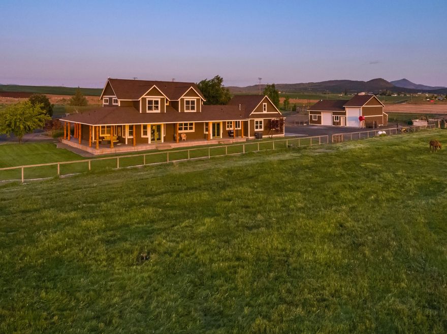 Prepare to fall in love with this stunning farm property! It's everything you're looking for - a gorgeous, luxury, custom farmhouse estate home with unobstructed, breathtaking, panoramic views of the Cascade Range.  This farm includes a sizeable workshop with enclosed RV parking and a sturdy horse barn with full-sized riding arena. Additionally, you'll find 150+ irrigated farm acres, 130 acres under center pivot, and a well-built, solid hay barn. Other highlights: paved driveway, wraparound farmhouse porch to soak in the views, hot tub hookup on porch corner, above ground pool pad, garden shed in yard with gardening beds in surrounding areas, Peachtree wood-framed windows throughout the house, beverage refrigerator in kitchen island, clawfoot soaking tub in primary bedroom, a showpiece knotty alder and juniper staircase, and an enclosed library room. This dream property is a must see - you'll find you won't want to walk away..