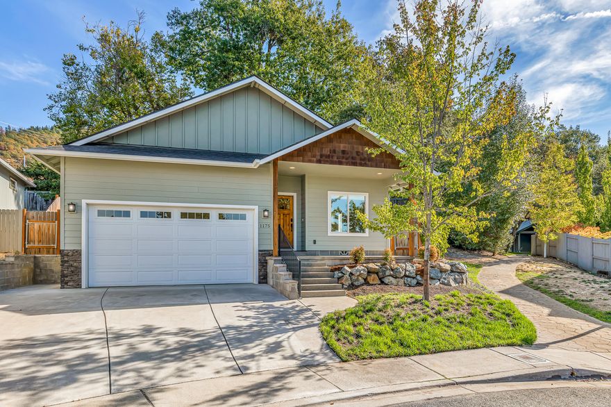 Newer single-level home in a desirable cul-de-sac located near parks, schools, shopping, and restaurants of NE Grants Pass! Vaulted open-concept living with engineered wood floors, kitchen with granite counters and dining island, soft-close drawers and doors, stainless appliances including new Whirlpool five-burner gas range oven with griddle and Frigidaire refrigerator, primary bedroom with sliding glass door to private covered back porch, full ensuite bathroom with granite double vanity, oversized shower, walk-in closet with built-ins, guest bedroom with closet, full guest bath with tub shower, and a spacious two-car garage. Fully fenced backyard with cascading water feature, terraced gardening areas, poured concrete patio, storage shed, and expansive view deck. Property backs to a 0.38-acre common area with grass lawn, mature trees, and covered gathering area. Association dues of $150 per month cover all water plus common area maintenance and electricity. Inquire for details!