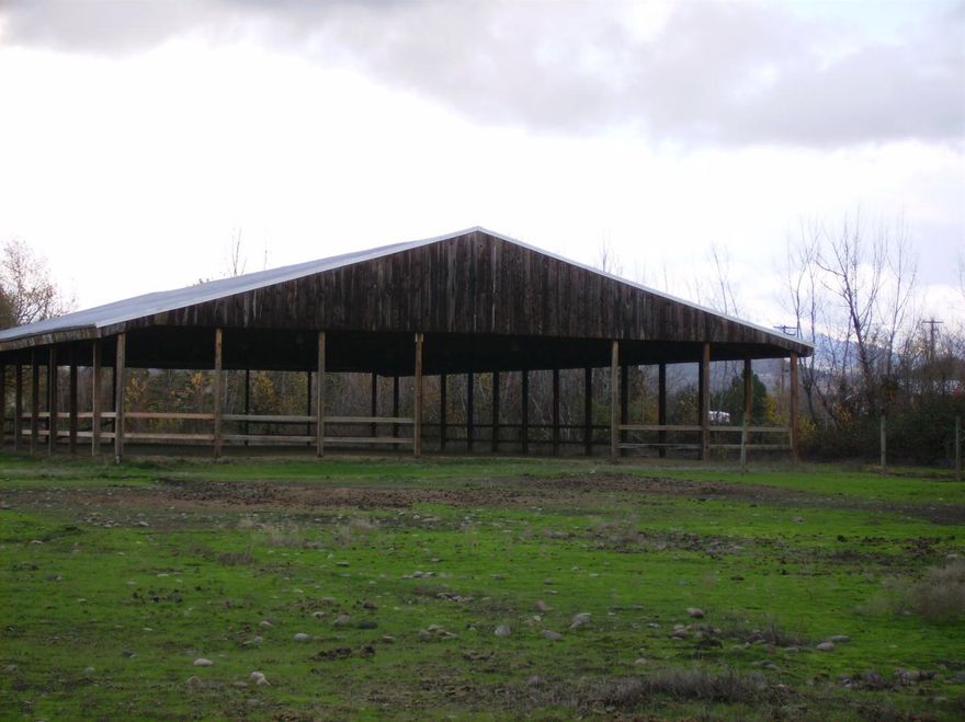 Home, Arena, Irrigated Acreage, Barns, Outbuildings. Outstanding potential, location and price. Covered and lighted 75 by 150 ft. Arena. 2 Barns. One has 6 nice stalls. Other has 3 stalls and 7 bays that could be stalls or hay, shavings, equipment storage. Nice tack room with saddle racks. 2 additional outbuildings can be shops/garages. 5 useable acres with 4 irrigated. Fenced, cross-fenced. Nice trees add some privacy. Home and structures sit back off road. Country close-in location with gorgeous views of surrounding ranches and Mt. McLaughlin. Few minutes to E.P. and Stone Ridge golf courses, shopping and schools. 3 bed 2 bath home with nice wood floors, fireplace, newer heat pump and on City Water. Rogue Valley Sewer available at the street. Bring your horses, livestock, vehicles, dreams. With a little polish, this gem will shine.