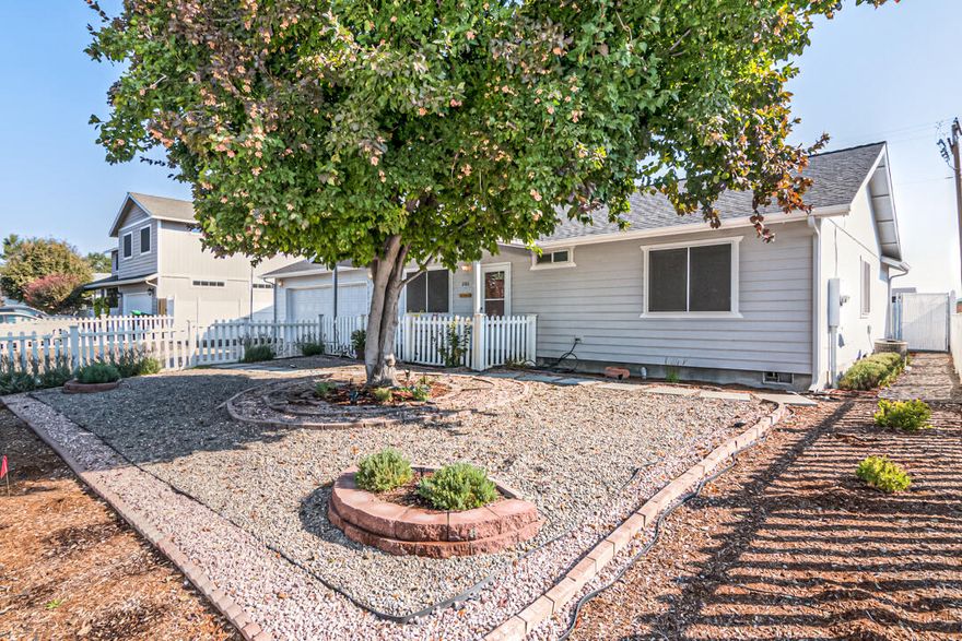 Welcome home to this charming neighborhood nestled in the center of Prineville. Some of the features of this well cared for home include solar privacy screens, storm doors, new laminate flooring, new HVAC system, large craft/workshop and so much more. Outside you have a lovely low maintenance yard, covered patio, pull through RV parking with hookups and a storage shed. Location is hard to beat with a unique set up! Gate from back yard gives access to Elementary School and the Crook County Stadium. The Middle School is one block north and High School is 4 blocks to the south! Inside you have an open concept floorplan with tons of natural light. Pride of ownership is evident throughout this lovely home. Shown by appointment only.