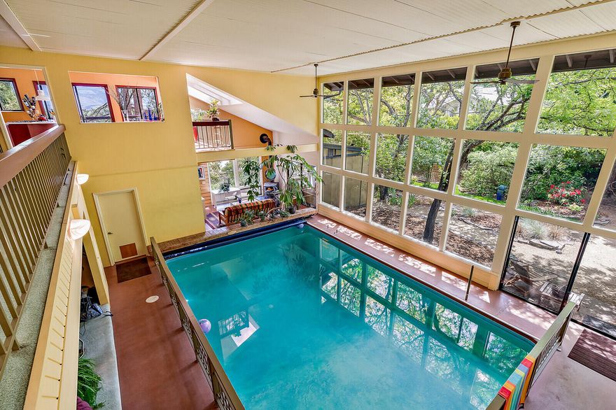 Are you looking for that sanctuary to call home? A wall of windows inviting nature into your home? Gorgeous views from the whole house into the beautifully landscaped yard, designed by a local professional, as well as valley views off the dining area and outside deck spaces. Close proximity to town in this desirable location just blocks to downtown. 
Have there been times where you've just felt stuck in your house for days, or even weeks? Does going to the gym feel like a thing of the past?  Imagine the fun of jumping in your own personal pool and never taking a step outside. The real question isn't can we afford an indoor pool, but can we afford not to have an indoor pool.
Unique homes are not for everyone, and if they aren't for you, then this is not your house. But if you are fun, whimsical and like to be a little bit different, in a good way, then come take a look at this beauty.  Enjoy your coffee by wood burning stove or have a get together in the family room next to the pool.