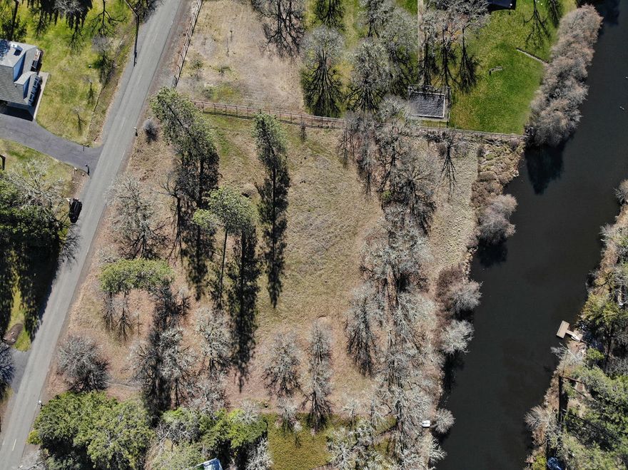 Beautiful 1.90 acres waterfront property w/ close river access in exclusive Gold Ray Estates! Bare land with extras which include the following: New well a cost of about $15K. Well is registered w/ the state. No well pump or power. Lot was re-surveyed to identify corner stakes/ boundaries & lot is clearly marked & extends into the manmade pond. Septic approved & estimate for septic is on file from Dunlap Septic. Well is 460 ft @ 6 gpm. Owners have rights to irrigate out of the manmade pond. Homeowners association dues are $400 yearly. HOA for 2021 has already been paid for by the current seller. Seller also has on file a Home design/ build done by Ron Grimes the Architect, this alone cost about $4000. Property is permitted to have a private small boat dock to the manmade pond. Owner paid for a street address to be done with the county. Common area in the community w/ private and calm swimming area, boat launch & easy access to the Rogue River as well!