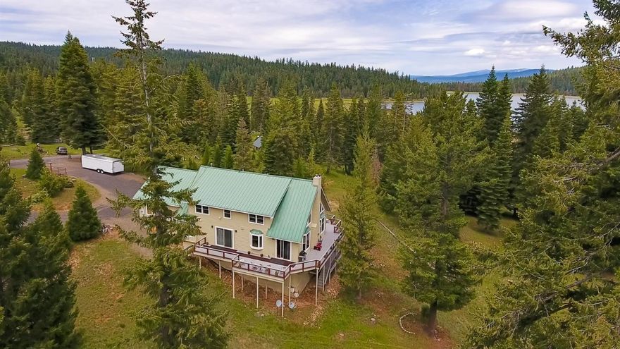 Large custom home built to enjoy quality time with family & friends. Enjoy spacious living year round or as a vacation retreat. Only one owner & never on the market before. Well thought out tri-level floor plan offering a nice separation of space for family & guests. Quality features throughout. Granite counter-tops, six burner Wolf range, Stainless steel appliances, Reverse Osmosis, overhead cam lighting, accent lighting in the ceiling, wide plank wood floors, tile radiant heated bathroom flooring, River rock fireplace, jetted tub & double vanities in master bath, Fir wood detailing throughout, crown moldings, vaulted ceilings, metal roof, 2 tank-less water heaters & much more. Good well & a 35 gal. pressure tank for constant water pressure to the home. Sit back, surround yourself with the serenity of nature and the peaceful views of Hyatt Lake on you large wrap around deck. Unwind & get away from it all. It doesn't get much better!