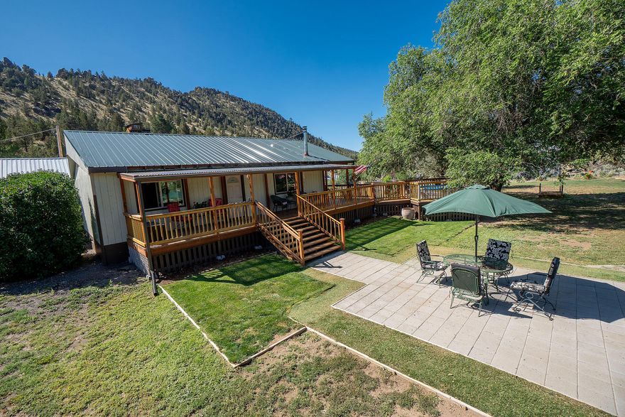 Peaceful 1-acre setting just 2 miles from Prineville Reservoir! Fully fenced & nicely treed with beautiful views, this property offers an 18x24' horse barn w/2 stalls, power & water, corral, fenced dog run, horseshoe pit & 8x12' shed w/windows. Circular drive with 2 gated entries, detached garage, carport, screened porch & heated studio/flex space. Home was fully renovated to the studs—updated electrical, plumbing, water heater, wood stove, flooring, metal roof w/gutters, garage door, 2 septic tanks, leach field, well pump house & 80-gal pressure tank, electrical panel in garage. Updated kitchen boasts tile counters/backsplash, SS appliances, hickory cabinets w/under-cab lighting & French doors. Bath features elegant tiled shower & newer vanity. Forced air heat & wood stove keep it cozy. Enjoy the huge wraparound deck, paver patio, cowboy pool, w/hot tub hookups available. Full RV hookups w/power & water & separate septic tank. Not a drive-by—must see to appreciate!