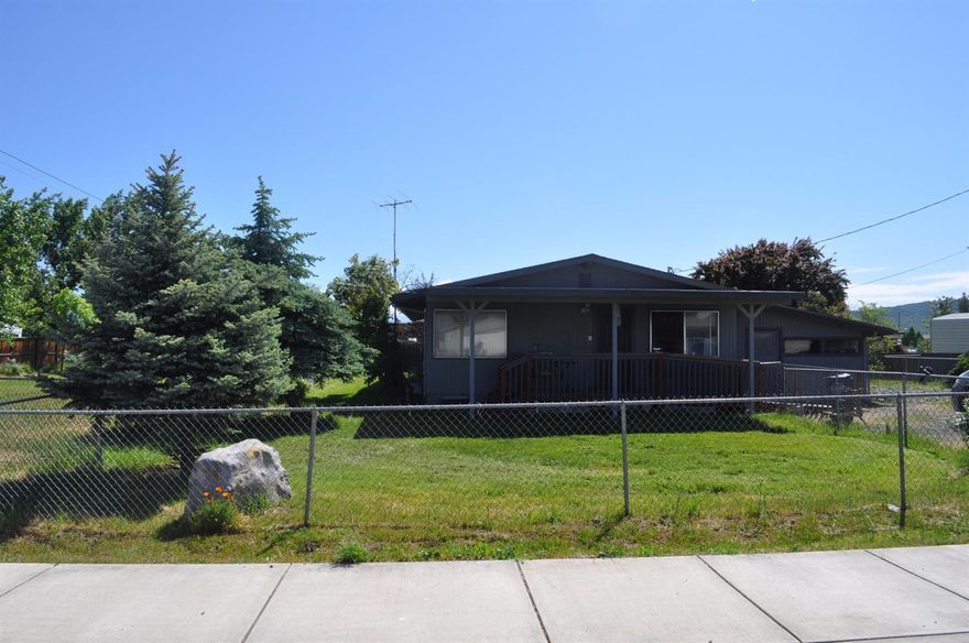Quaint, White City home on a .56 acre lot zoned WCUR-8. Home features 3 bedrooms and 2 baths, open and bright galley kitchen, good sized mud room, free standing gas stove in living room, attached storage/shop, and front porch with ramp and covered back porch. Some upgrades include newer kitchen cabinets and countertops, new master bath vanity, new vinyl in bathroom and mud room, and newer water heater. The outside of home was just freshly painted. Outdoors you can enjoy 3 water features, an above ground pool, large, fenced side and back yards, additional storage/shop and there is a well for irrigation. The large, fenced side yard has a separate driveway and could be used for RV parking. Check with city to see about possibilities for 4H projects, additional units or ???. So many possibilities for this unique property!
