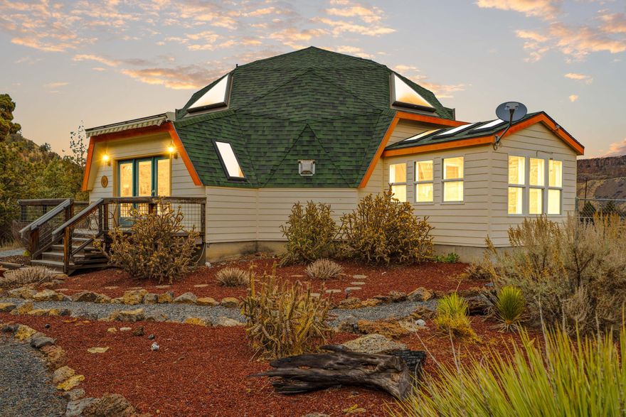 Unmatched beauty and craft in this unique Geodesic Dome, known for superior architectural strength &
quality. Features include limestone tile, marble flooring in baths, a true chef's kitchen w/ granite
slab counters, maple cabinets, glass cooktop, double-oven, storage island w/ prep table, farmhouse
sink & pantry. Bedroom on first floor has two closets, including a large walk-in. Upstairs, the primary
suite features a private office, loft-style bedroom with built-in cabinets, walk-in closet, huge bathroom
w/ marble counters & double vanity. Enjoy panoramic views of the Crooked River Canyon Ridge from the wrap-
around deck & direct access to adjoining BLM land. HUGE 4-bay shop of dreams: electric openers, lean-
to & insulated/heated workshop w/ hard-plumbed air compression, hot water, 200AMP circuit. Fenced area off
the home for your pets and plenty more room for horses! RV hookup, low-maintenance landscaping, AND SO MUCH MORE!