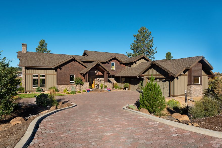 Cascade Mountain views from this northwest style home on the 13th green in Tetherow. Grand foyer with travertine floors and wall water feature. Great room with 21' vaulted ceilings, stone fireplace and solid hickory floors. Gourmet kitchen with solid granite counter tops, walk-in pantry, and kitchen island with Decor cooktop is perfect for entertaining. Dining area has floor to ceiling windows to enjoy the spectacular views. Outdoor covered living area w/built-in BBQ, sink & refrigerator. Ceiling fans, heat lamps and fireplace provide year-round enjoyment. Paver patio w/fire pit overlooking pond w/beach, golf course, lake and Mt Bachelor views. Main level master suite w/dreamy bath, his & hers walk-in closets, and sauna. Additional bedroom, office or den located on main level w/full bath nearby. Upstairs loft w/deck serves 3 bedrooms, 2 baths and bonus space. Huge driveway w/plenty of turnaround room to accommodate the oversized 4 car garage. Perfect  for all your Central Oregon toys.