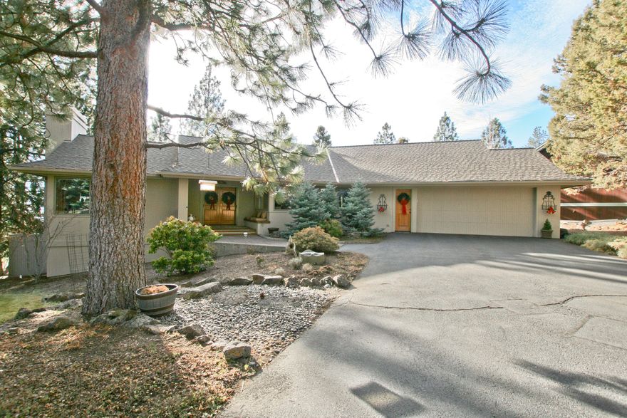 Sought after Awbrey Butte single story Steven Van Sant designed home with a fully finished daylight basement on a large .95 acre lot with city views! 
Nice, level driveway leading into a large two car garage. Living room includes vaulted ceilings, floor to ceiling stone fireplace, wired for sound and deck access. Formal dining room and a light and bright breakfast nook. Chefs kitchen with a view! Granite counters, Dacor refrigerator, Garland range with double oven and built in wine fridge. Master on main with updated master bath and powder room with radiant floor heating, walk in closet and private deck. Main level has den with built in bookcases and private deck that is shared with the master.  House is wired for security system.
Amazing decks on both levels. Built in hot tub and fire pit on the lower level.