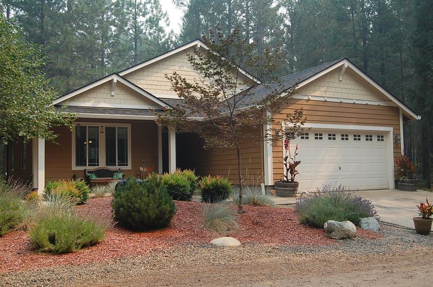 Attractive newer home located on 5 semiprivate acres that looks like a park in the forest. The landscaping is perfect for the setting. The home features vaulted ceiling in the open concept living room, dining area, kitchen. Beautiful laminate flooring flows through these areas. The kitchen features faux granite counter tops, an island offering a lot of counter space and lots of storage, stainless steel appliances. The 3 bedrooms are carpeted and vinyl flooring in the 2 baths. Attached 2 car garage and room to park all your toys and/or build additional out buildings. All this and less than an hours drive to the coast.