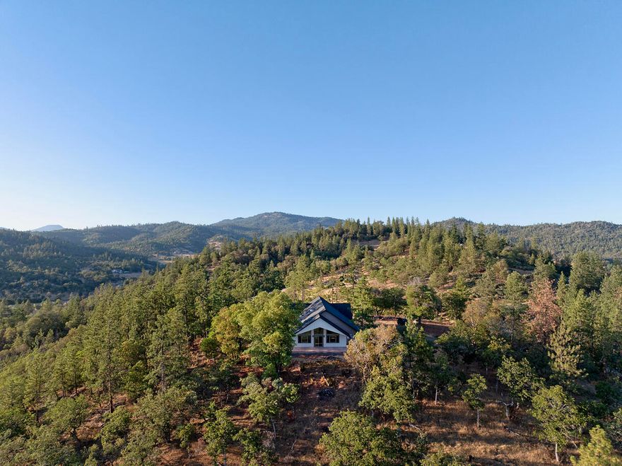 Nestled within the Central Point School District amidst 10 expansive acres of pristine natural beauty, this newly built custom home, completed in December of 2024, offers an unparalleled sanctuary of privacy and tranquility. Designed with meticulous attention to detail and a commitment to luxurious living, the stunning residence provides a peaceful escape from the hustle and bustle of everyday life.

The generously proportioned 2,224 square feet of meticulously crafted living space features three bedrooms, each designed as a private haven for rest and rejuvenation. Complementing these are two luxurious bathrooms, thoughtfully appointed with high-end finishes, promising a spa-like experience. The open-concept design seamlessly connects living areas, creating an inviting atmosphere ideal for both intimate gatherings and grand entertaining. Large windows throughout the home and a double-deep, four-bay garage provides ample space for boats, snowmobiles, and a variety of other toys.