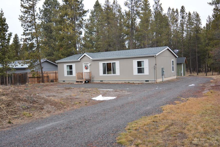 This home has been lightly used and is in like new condition with upgraded high end carpet throughout this 3 bedroom, 2 bath home built in 2017 on .44 acres with 1320 sq ft. Open living area, kitchen with knotty pine cabinets, stainless dishwasher, Frigidaire refrigerator and wood floors. Master bedroom with walk in closet and large master bath. Plenty of room to store your toys in the detached garage. A 4th detached bedroom is on the back of the property with incinerator toilet, shower and sink, vaulted ceiling and loft area. Great for extra space when company comes. Located off a paved road and connected to community water. Close to Sunriver, Mt. Bachelor and Cascade High Lakes.