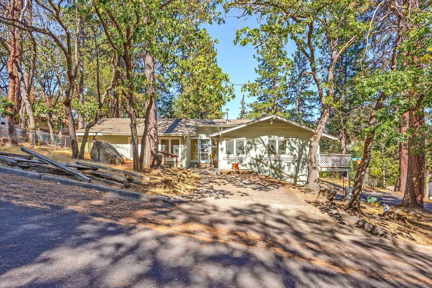 Wonderful mid-century modern home featuring a tiled entryway, panoramic-like windows, and an open floor plan. The main level master suite has vaulted ceilings, hardwood floors, a built-in Murphy bed, bookcases, walk-in closet, and large shower with lots of natural light. Amenities include casement windows, large front deck, and a formal dining/sun-room. The kitchen has bamboo flooring with access to a lovely back yard deck. An additional guest bedroom/office and full bathroom are also on the main level. Downstairs includes a study with an exposed staircase, tile floors, full bath, bedroom with multiple closets, and large sliders that open to a private concrete patio. Don't miss this great home and fantastic location!