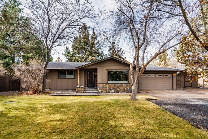 Ideal single level home in Sunset West on a private 1 acre lot. Enjoy this 3 bedroom, 3 bath, 1568 square foot home that sits on over a full acre in NW Bend. Cozy up by the real vintage fireplace in the sunk in living room. Open kitchen & dining overlooking the park like setting back yard. Back yard has walking paths between rock outcroppings, garden beds, greenhouse, covered entertaining area, multiple sheds and shed/shop with electrical. Large entry parking area perfect for RV, boat or trailers.