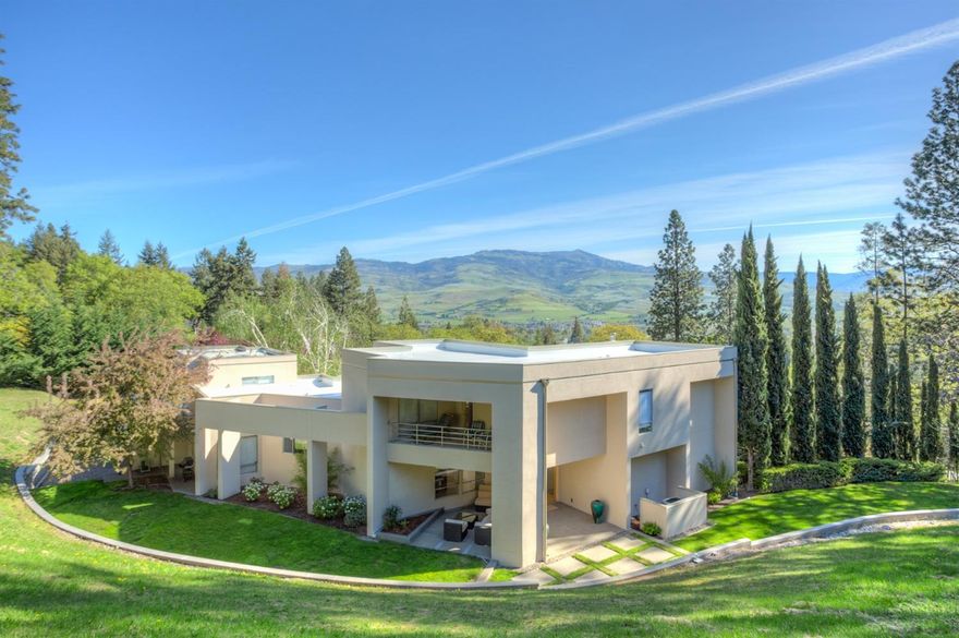 Sleek and modern. Architecturally designed by David Strauss & built by Vitus Construction this outstanding custom home sits directly above Lithia Park! Private & rare one ac site w/gated entrance. Formal living room with floor to ceiling curved glass wall showcases gorgeous views. Wide elegant steps lead to formal dining. An entertainer's dream this home shines with use of select solid white oak & Italian marble floors as well as expansive ceiling heights. Cooks kitchen opens to family room, casual dining & outdoor patio. Custom soft close cabinets throughout & professional brand appliances. Lovely separation of space with Owners suite including large office, bedroom with mountain views, walk in custom closet, bath with step in glass tiled shower & spa tub. The additional 2 bed 1 bth wing allows for privacy from guests or family. Indoor/outdoor entertaining leads to multi-level covered patios w/audio& lighting. A gorgeous design and setting provide a sense of tranquility.