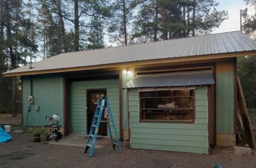 $30,000 Price Drop!  Escape to Beautiful Central Oregon! This 896sf shop building was converted over time to a cute and cozy recreational cabin. Sale is AS-IS.  Great vacation base, project for a contractor, or build your home here and use cabin for a guest house or an ADU? Small 320sf 2-bay garage. Covered deck. 2 Full RV Hook-ups. Metal roof on all buildings. The 3 year old well produces 20 GPM. Septic tank will likely need to be replaced eventually, but drainfield passed inspection in 2022. Lots of trees for privacy and only one block from paved road. Close to La Pine State Park, Deschutes River, Newberry Caldera National Monument, and Cascade Lakes Scenic Byway.  Buyer to do due diligence with Deschutes County on all building codes and property uses.