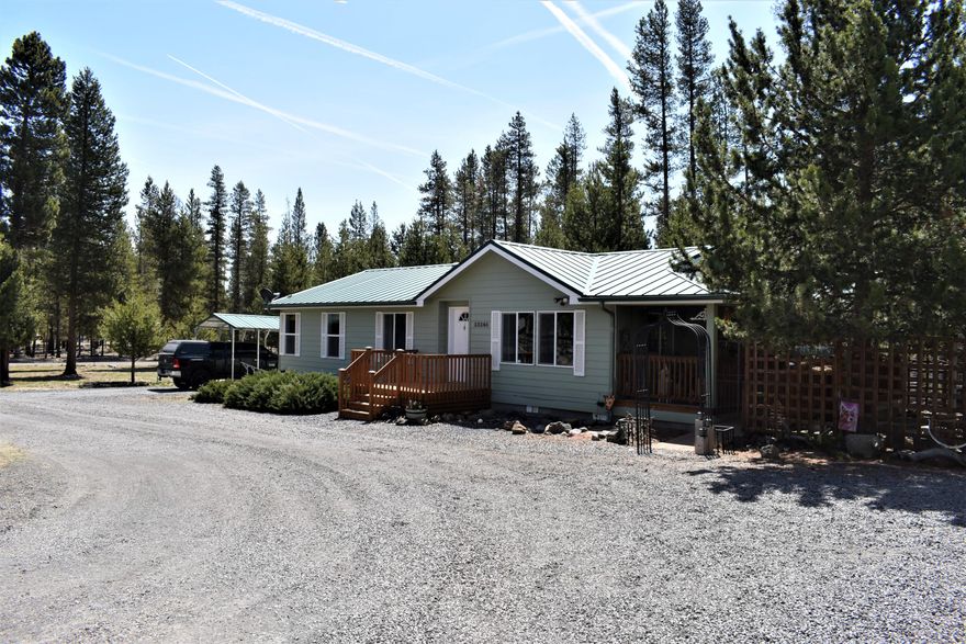 Wonderful Home located just off the Oregon Scenic Byway and Hwy 31 in Sun Forest Estates! Very clean and well-kept home and property! 2008 3 bed 2 bath 1350 sq ft Manufactured home that has an open living concept. Nice functional kitchen with bar, counterspace, seating and storage. Situated on a fully fenced and gated corner lot and includes a 20x20 two story detached one car garage that has a second story storage area,10X20 Hickory Cottage shed, 8X10 Hickory Garden shed, Metal RV Cover that will store a trailer and Boat, and a Metal Car or Truck Cover. Property also features, a large, covered patio right off the dining room for a great spot to sit or BBQ! Also includes a small smokehouse! So Unique! This property has plenty of room to bring your toys to enjoy the many recreational areas that surround this property! Only 10 minutes from downtown La Pine for shopping and amenities!