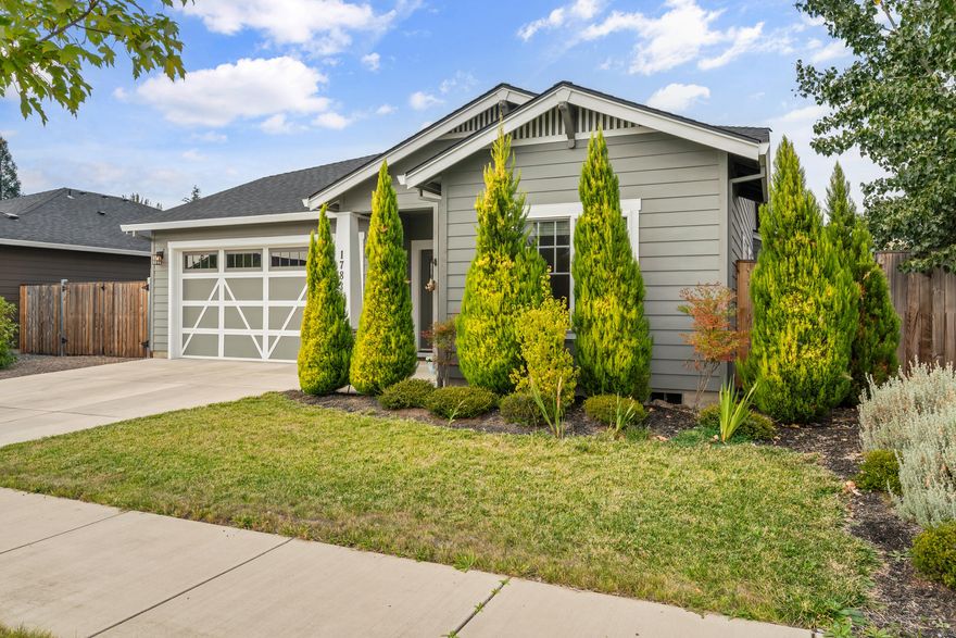 Stunning 3-Bedroom, 2-Bath Home in Northeast Medford. Built in 2019, this single-level home offers modern finishes and a spacious open floor plan. Vaulted ceilings and abundant natural light create an expansive feel. Luxury vinyl plank flooring flows throughout the main living areas. A cozy gas fireplace in the family room, seamlessly connected to the kitchen and dining area. A chef's delight in the kitchen featuring granite countertops, a large island with seating, stainless steel appliances (refrigerator, range, dishwasher, microwave), and ample cabinetry. The large primary bedroom boasts vaulted ceilings and an ensuite bathroom with a dual vanity, granite counters, tile flooring. Dedicated laundry room for convenience. Fenced backyard with patio and garden beds perfect for outdoor relaxation. Situated in a quiet neighborhood, close to amenities.