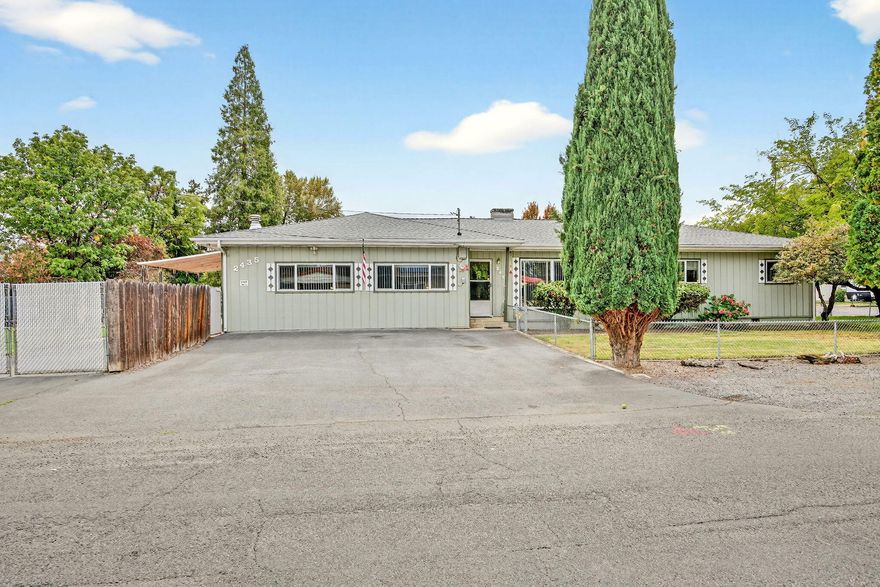 GOT TOYS?  This unique property is a dream come true!  Perfectly situated on a spacious 0.31-acre corner lot in a well-established neighborhood, this 4-bedroom, 2-bath home offers the ideal setup for those who need space to store, work, and play. There's paved parking for multiple vehicles, plus a 74-ft gated RV parking area, w/one automatic gate for added convenience. Multiple attached shop spaces with separate entrances, provide room for hobbies, storage, or projects of all kinds. Inside, you'll find brand new carpet throughout, new laundry vinyl flooring, remodeled kitchen w/pantry & eating bar, an indoor laundry room w/ample storage. Enjoy peace of mind w/a newer roof (installed 2023) & newer solar system, to help keep utility costs low. Outdoor features include a recently redone covered patio, dog run, storage shed & fully fenced yards w/sprinkler system. Conveniently located near Rogue X, shopping & local amenities, this property is a must-see for anyone w/big dreams & big toys!