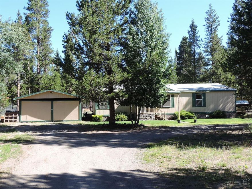 Well taken care of manufactured home on fully fenced 1.25 acres, minutes from downtown La Pine. Three full bedrooms plus a den/office! Lightly landscaped with in-ground sprinklers in front, covered front and back porch! Firm foundation, on well & standard septic. Some interior fresh paint. Laminate flooring in all but the bedrooms. Unfinished garage, but will keep you vehicles covered in winter. Priced to sell quickly, motivated sellers.